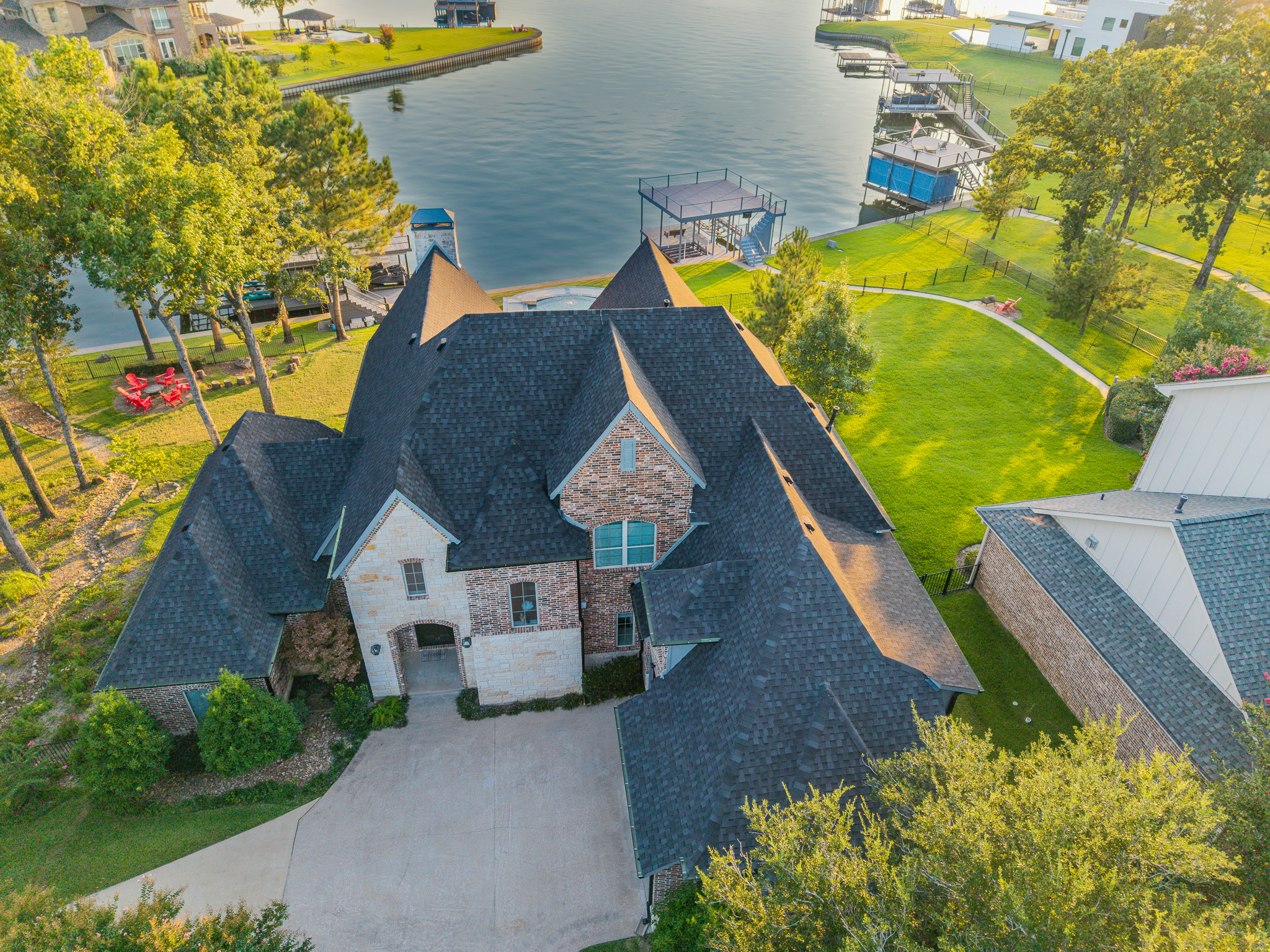 Aerial view of the lakefront villa, lawn, private dock and cove
