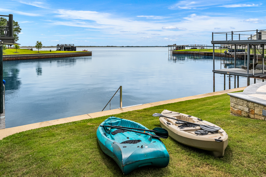 Kayaks ready on the lawn beside Cedar Creek Lake