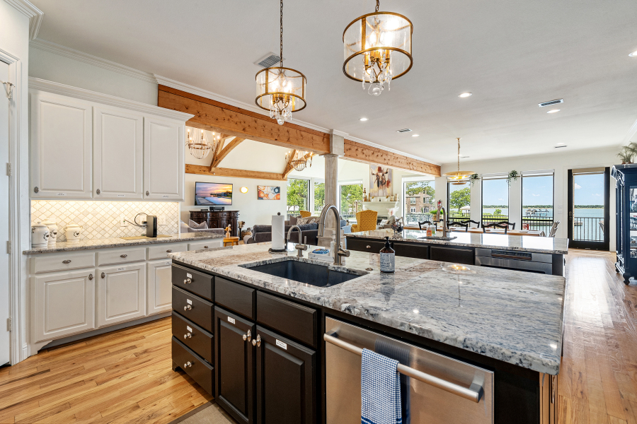 Gourmet kitchen open to the dining area and lake views