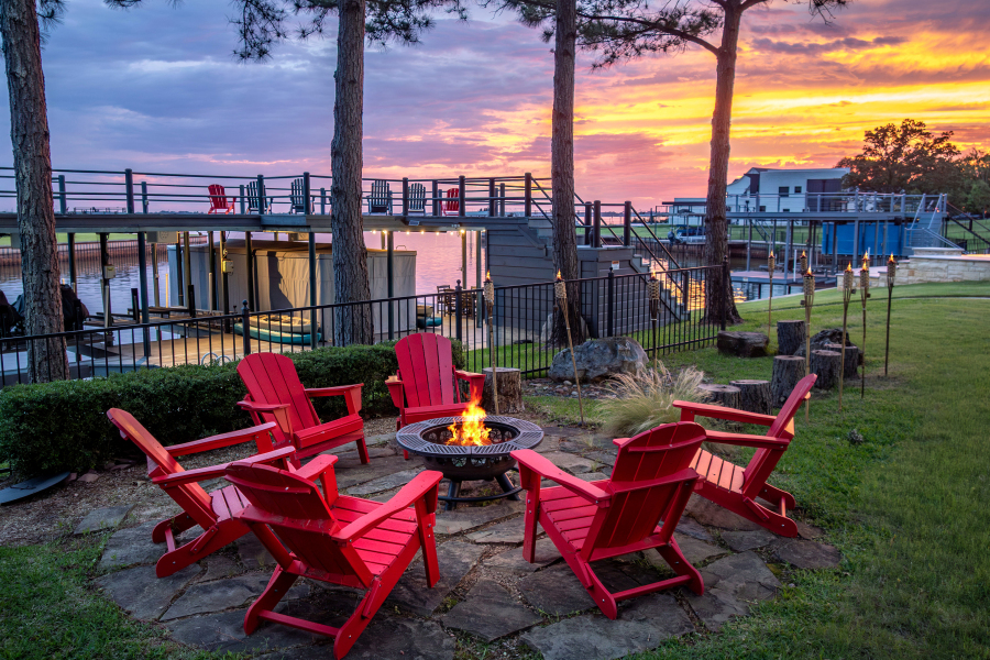 Outdoor fire-pit seating with a private dock and sunset lake views
