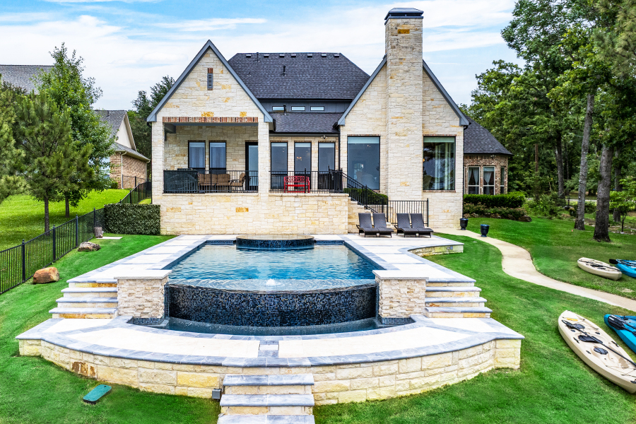 Daytime infinity pool, villa exterior and kayaks