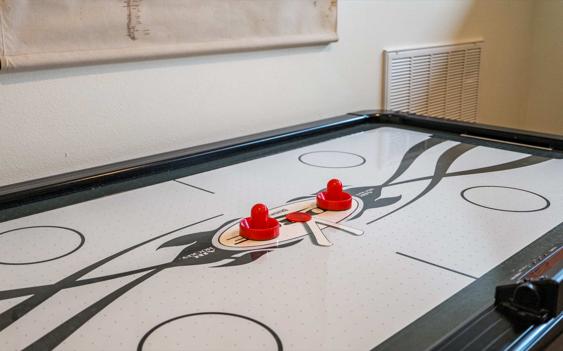 Air hockey table in the game room